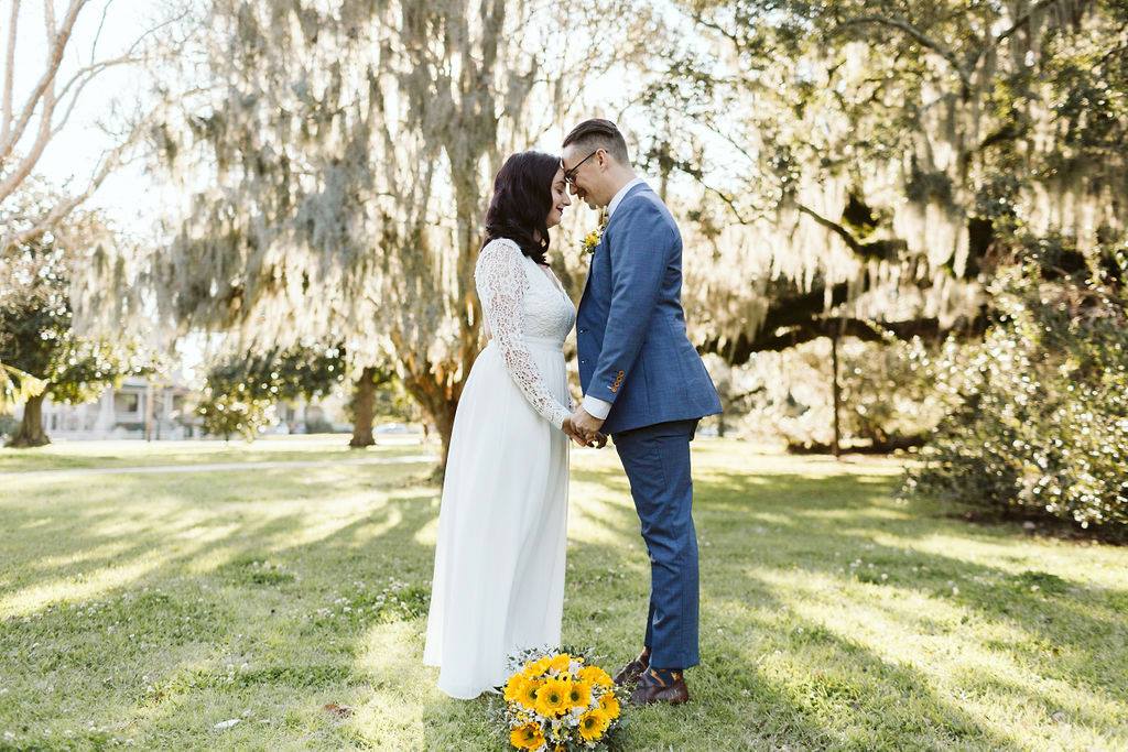 Why Elope? | Newlyweds embrace in City Park New Orleans