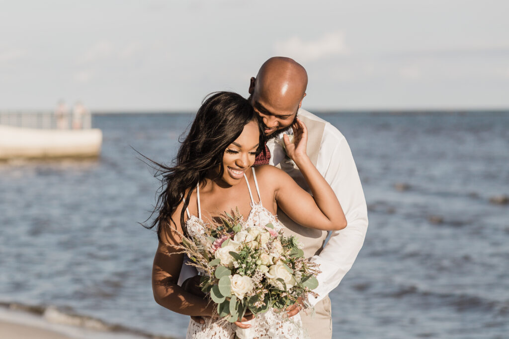 Newlyweds embrace after their Biloxi Beach wedding