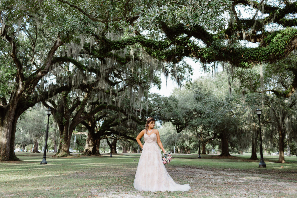 Bride poses beneath oak trees in Audubon Park's Oak Alley | The Best Places to Elope in New Orleans