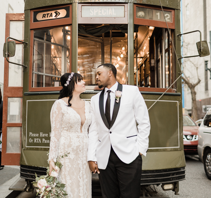 Newlyweds pose in front of a streetcar after their New Orleans elopement | the best places to elope in New Orleans