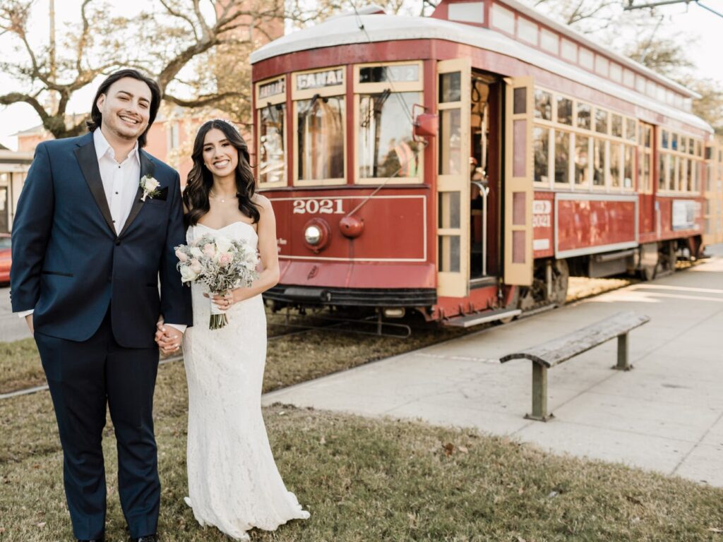 Newlyweds pose next to historic New Orleans streetcar following their elopement