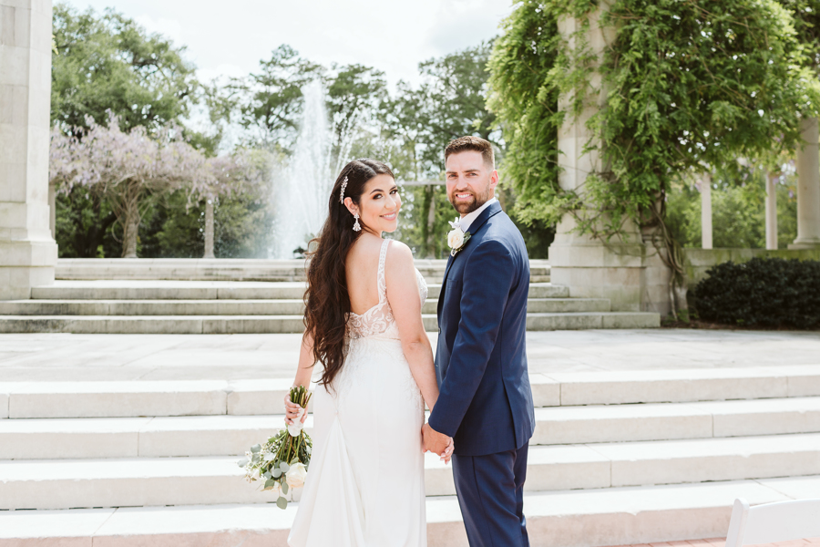 Newlyweds stand in front of Popp Fountain in New Orleans City Park