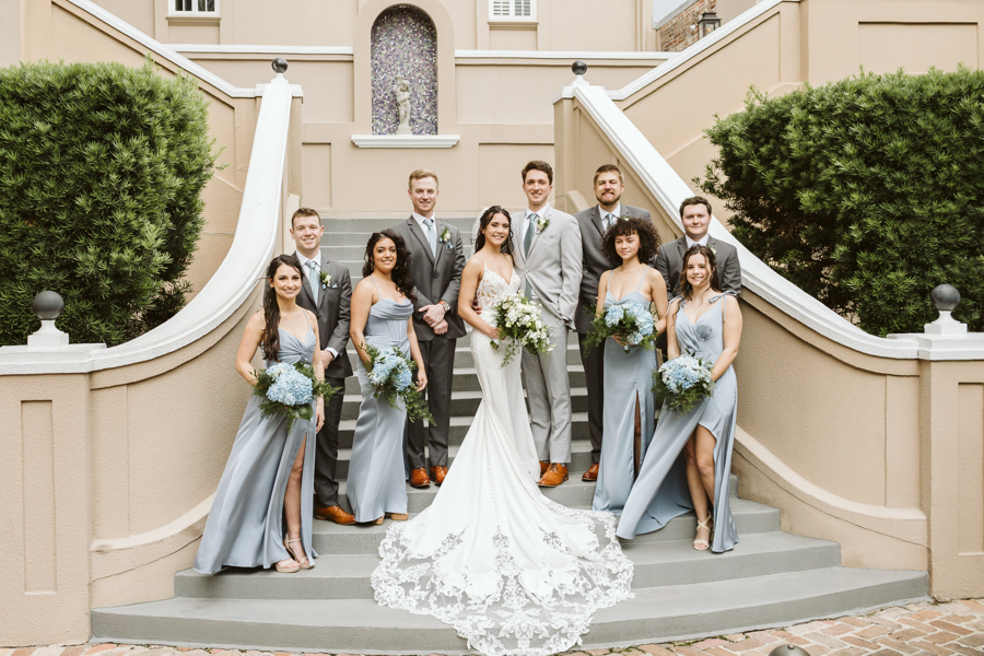 Bridal party poses on a staircase in the New Orleans French Quarter