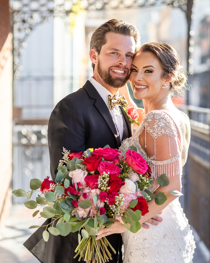 Newlyweds stand on French Quarter balcony