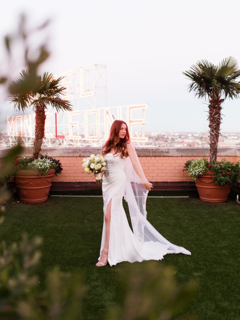 bride poses on the rooftop of Hotel Monteleone