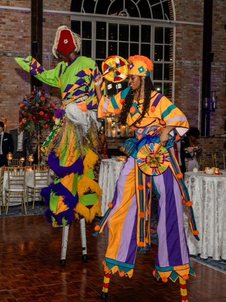 Stilt walkers perform at wedding reception